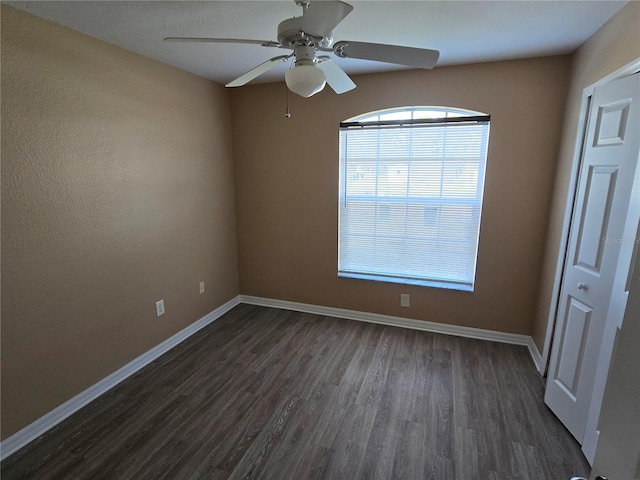 unfurnished room featuring dark hardwood / wood-style floors and ceiling fan