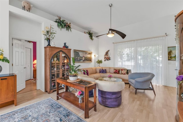 living room featuring ceiling fan and light hardwood / wood-style floors