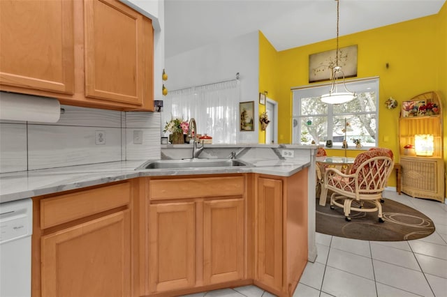 kitchen featuring sink, light tile patterned floors, backsplash, white dishwasher, and kitchen peninsula