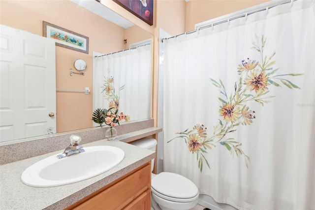 bathroom with vanity, curtained shower, and toilet