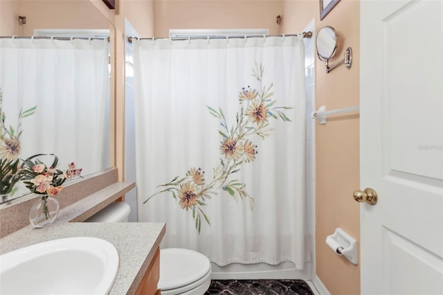 full bathroom featuring vanity, shower / bath combo, and toilet