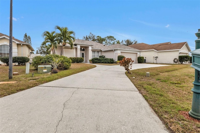 view of front of home with a garage and a front lawn