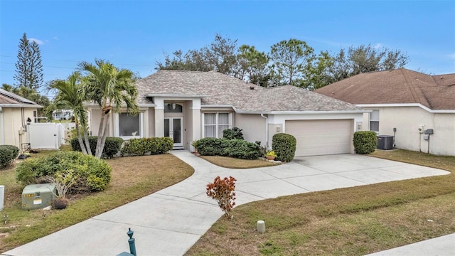 single story home with a garage, central AC, and a front lawn