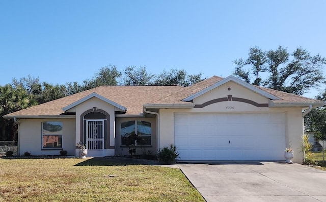 ranch-style home with a front yard and a garage