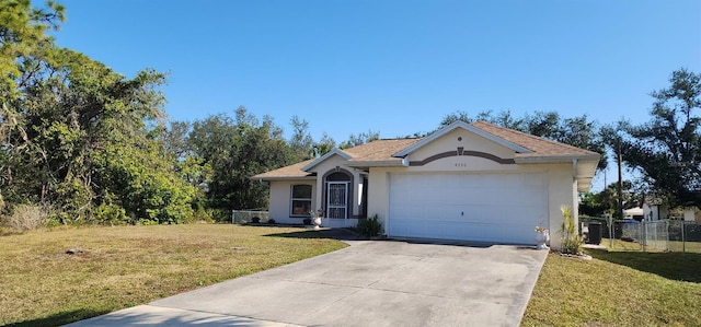 ranch-style house with a garage and a front lawn