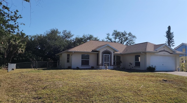 single story home featuring a garage and a front lawn