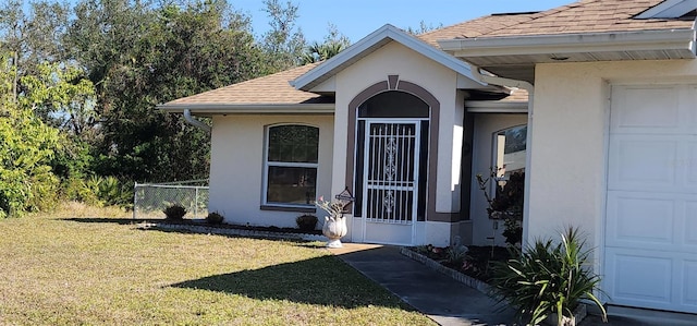 property entrance with a yard and a garage