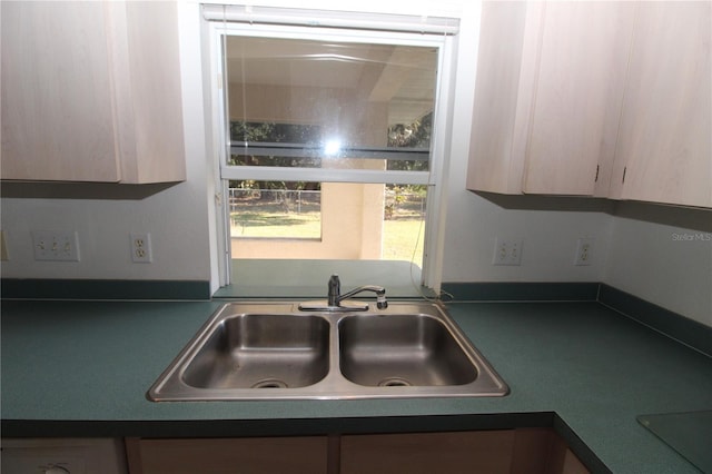 kitchen with sink, light brown cabinetry, and black stovetop