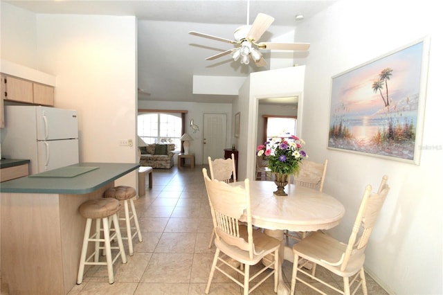 dining space with ceiling fan and light tile patterned floors