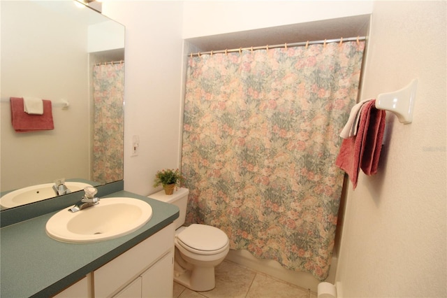 bathroom with toilet, tile patterned flooring, vanity, and walk in shower