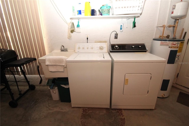 laundry area with sink, washing machine and dryer, and water heater