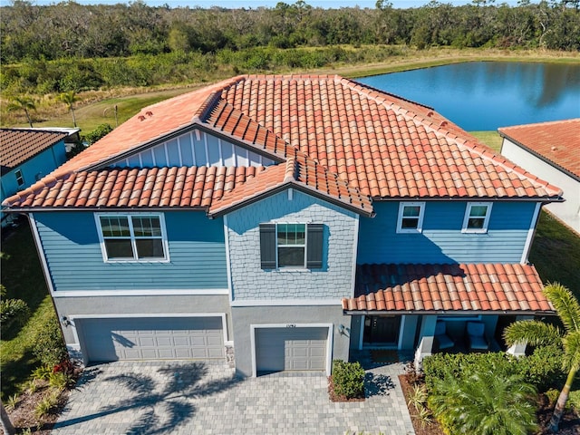 view of front facade with a garage and a water view