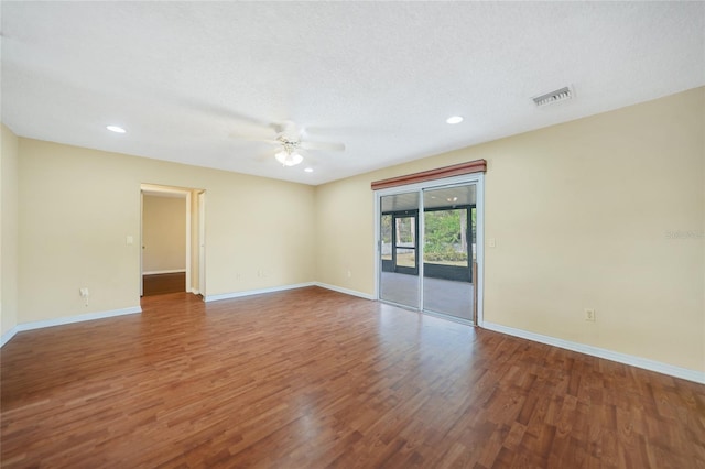 unfurnished room featuring dark hardwood / wood-style flooring, a textured ceiling, and ceiling fan