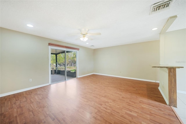 unfurnished room with ceiling fan and light wood-type flooring