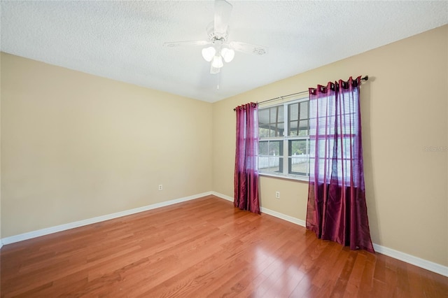 spare room with hardwood / wood-style flooring, a textured ceiling, and ceiling fan