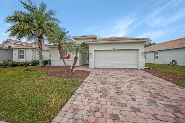 view of front facade with a garage and a front lawn