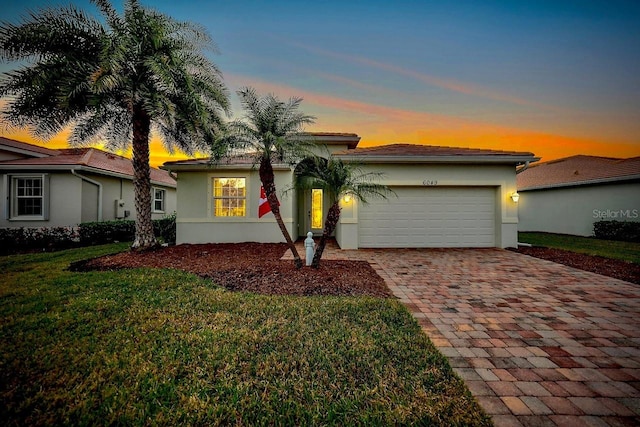 view of front of house with a yard and a garage