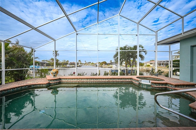 view of pool with a lanai, a water view, and an in ground hot tub