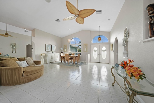 living room featuring ceiling fan, light tile patterned floors, lofted ceiling, and french doors