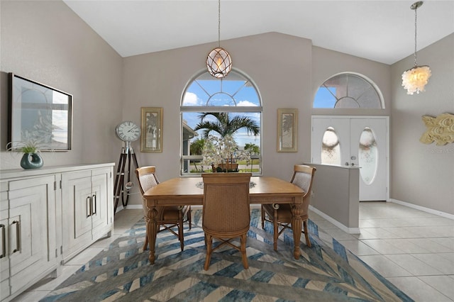 dining room with a chandelier, vaulted ceiling, french doors, and tile patterned flooring