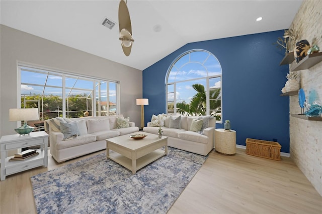 living room featuring lofted ceiling, a healthy amount of sunlight, ceiling fan, and light hardwood / wood-style floors