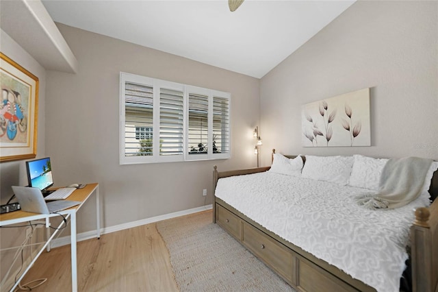 bedroom featuring vaulted ceiling and light wood-type flooring