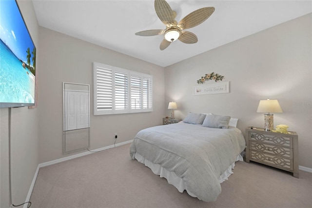 bedroom with ceiling fan and light carpet