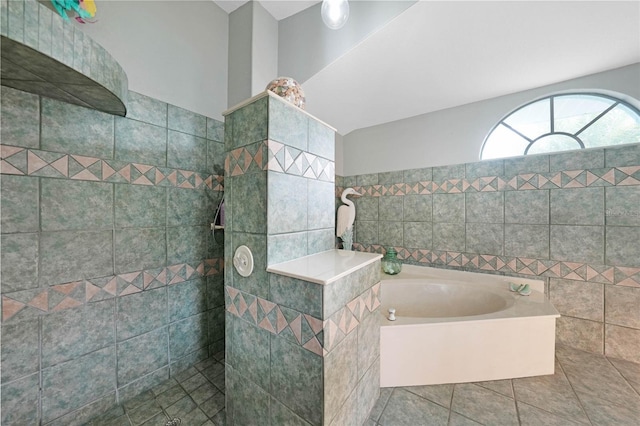 bathroom with independent shower and bath and tile patterned flooring