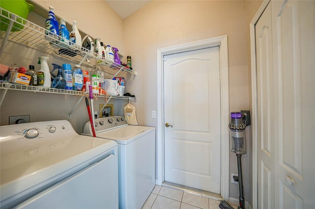 laundry room with light tile patterned flooring and washing machine and clothes dryer