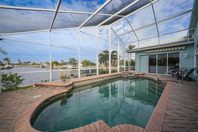 view of pool with glass enclosure, a water view, an in ground hot tub, and a patio