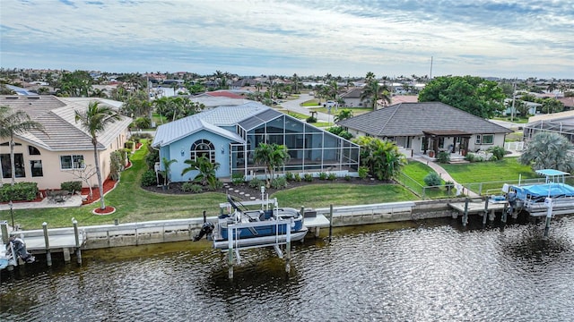 view of dock featuring a lanai, a yard, and a water view