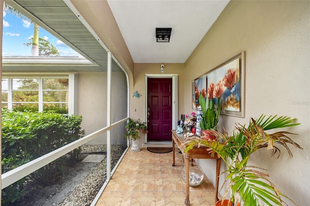 entrance to property featuring stucco siding