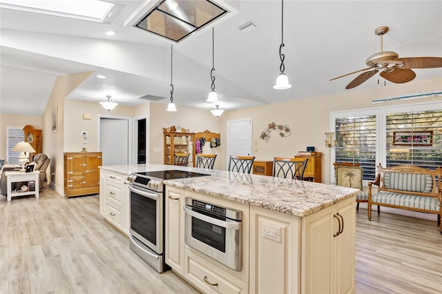 kitchen with stainless steel appliances, light stone countertops, and pendant lighting