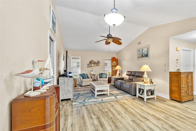 living room with ceiling fan, lofted ceiling, and light wood-type flooring