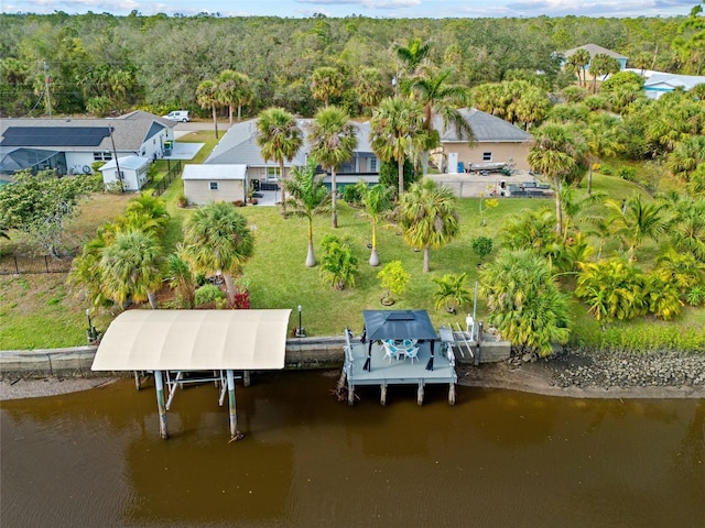 drone / aerial view featuring a water view and a view of trees