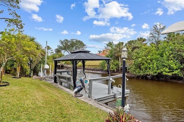 view of dock featuring a water view and a yard