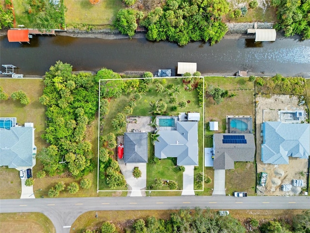 birds eye view of property with a water view and a residential view