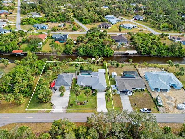 drone / aerial view featuring a water view and a residential view