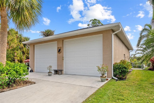 garage featuring a lawn