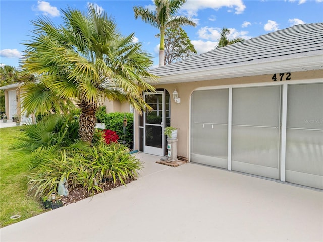 entrance to property with stucco siding