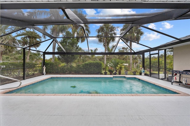 outdoor pool featuring glass enclosure and a patio area