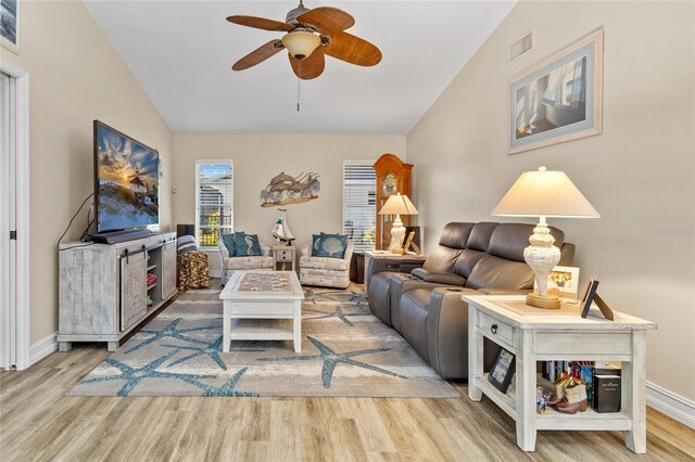 living area featuring baseboards, visible vents, a ceiling fan, lofted ceiling, and wood finished floors