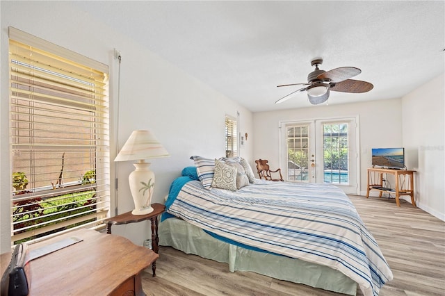 bedroom featuring ceiling fan, light wood-style flooring, baseboards, access to exterior, and french doors