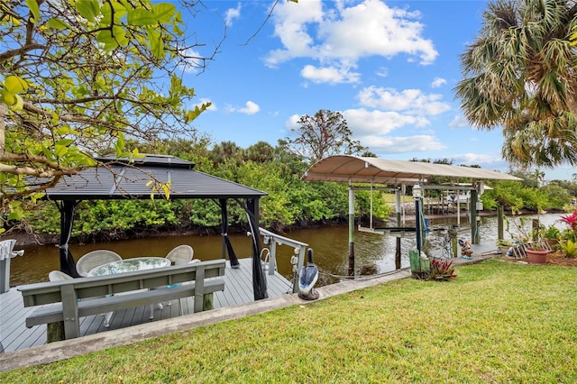 dock area with a water view and a yard