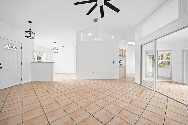 unfurnished living room with ceiling fan and light tile patterned floors