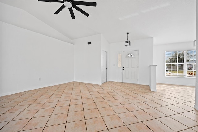 foyer featuring lofted ceiling, light tile patterned floors, and ceiling fan