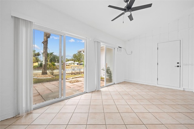 tiled empty room featuring ceiling fan