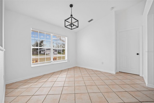 unfurnished dining area featuring vaulted ceiling, a notable chandelier, and light tile patterned flooring