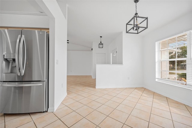 kitchen with light tile patterned floors, stainless steel refrigerator with ice dispenser, an inviting chandelier, and pendant lighting