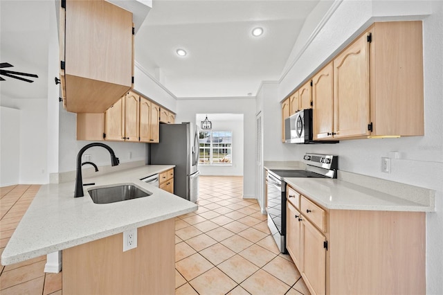 kitchen featuring kitchen peninsula, sink, a breakfast bar area, stainless steel appliances, and light brown cabinetry